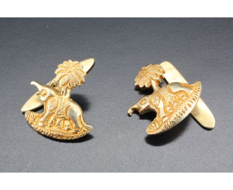 A pair of vintage high carat yellow metal cufflinks, modelled as elephants and palm trees, 9.8 g