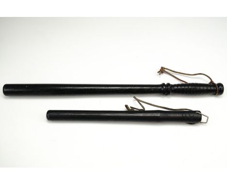 A US military police turned and ebonised wooden baton or truncheon, its pommel stamped "US", mid-to-late 20th Century, 55 cm,