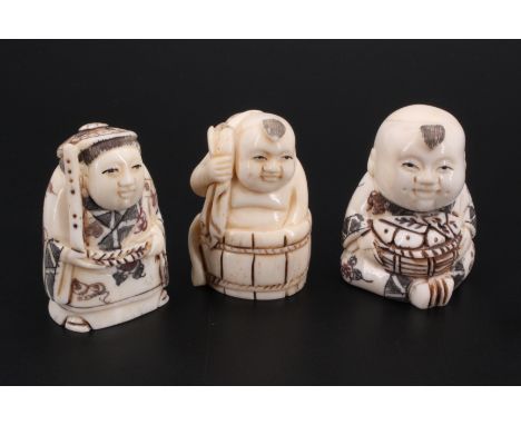 A carved bone figural netsuke together with two similar carved bone okimonos, tallest 5 cm