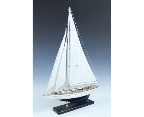 A model yacht on an ebonised wooden platform, 64 x 44 cm