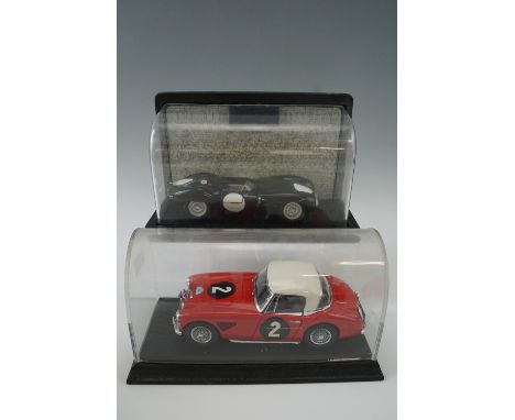 A cased Austin Healy 1:18 scale die-cast car together with a Jaguar D-Type 