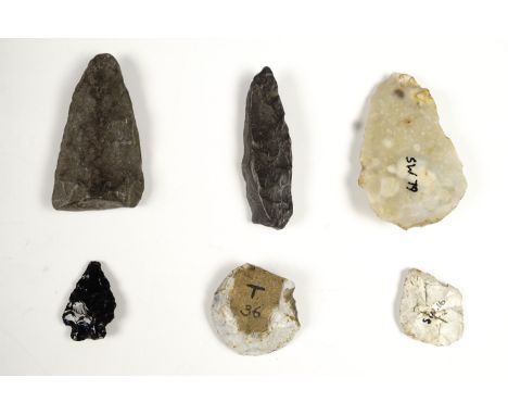 A small collection of pre-historic flint implements including arrow heads, some bearing old find / collection inventory refer