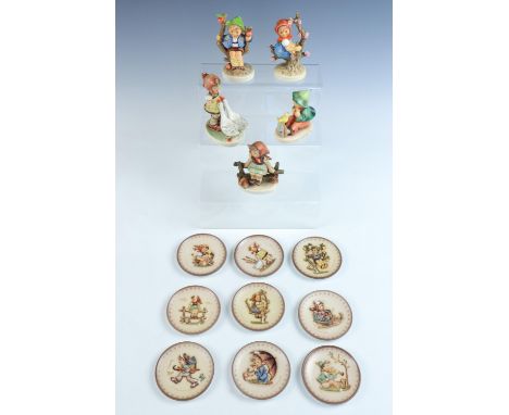 Five Hummel figures including "Singing Lessons" and "Apple Tree Girl", together with nine small "Hummel" plates, plates 8 cm