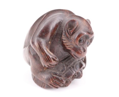 A Japanese carved wood netsuke of a monkey riding a turtle, 3.5 cm