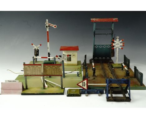 A Marklin 2230 O gauge tinplate level crossing, with picket fences, printed mark to base, 26.5 cm x 20.5 cm, a Kibri level cr