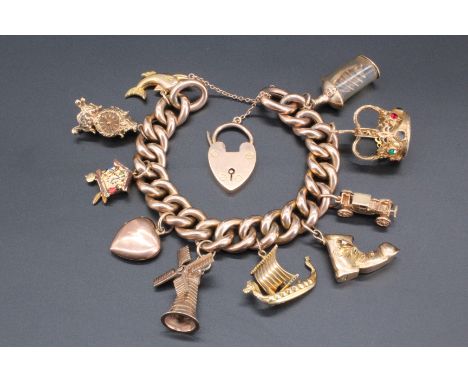 A vintage 9 ct / yellow metal charm bracelet, 80.1 g