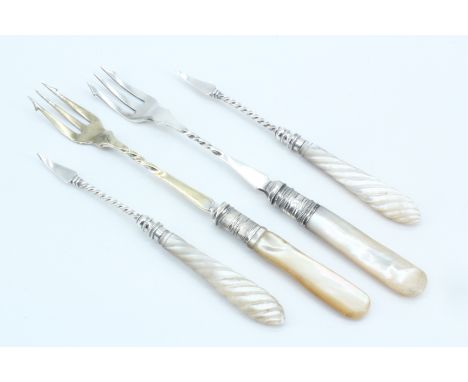 A pair of Edwardian mother-of-pearl electroplate pickle forks and two other picks