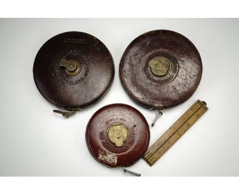 Three architect's / surveyor's tape Rabone measures, imperial markings, one with a repaired end loop, together with a vintage