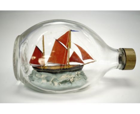 A vintage handmade Brixham Trawler "Valerian" ship in a bottle, 16 cm 