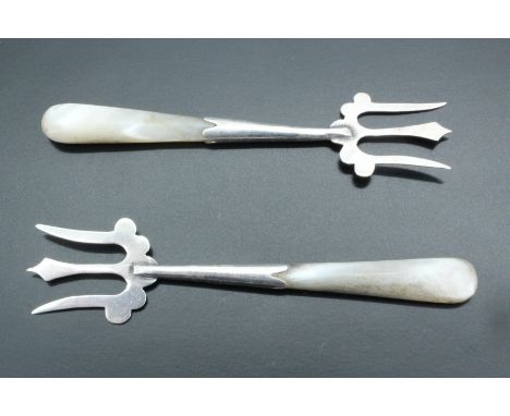 A pair of Edwardian silver pickle forks having mother of pearl handles