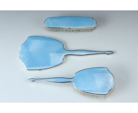A three piece blue enamel brush set