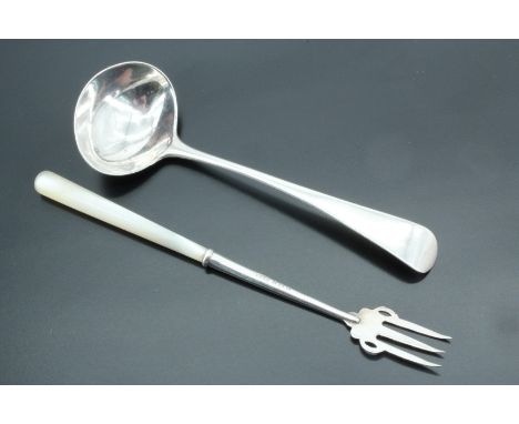A Edwardian silver pickle fork, having a mother of pearl handle, together with a silver sauce spoon
