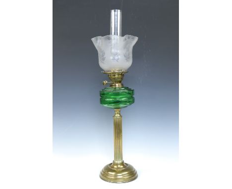 A Victorian brass columnar oil lamp with green glass reservoir, 74 cm
