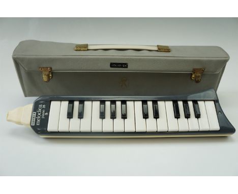 A cased Hohner "Melodica Piano 26" harmonica