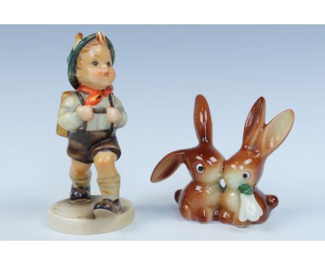 A Goebel figurine of two rabbits together with a Goebel Hummel figurine of a school boy, tallest 11 cm