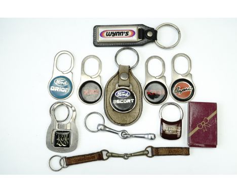 Eight car marque / model key rings including Orion, Escort, XR3I, XR2 etc