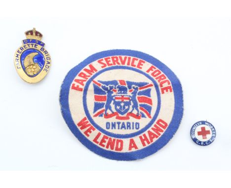 An OFSF Farmerette Brigade enamelled badge together with a Canadian Farm Service Force printed overalls badge and a Canadian 