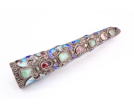 A Siamese silver and enamel finger ornament, having uncut polished stones in rubbed over settings along its length and applie