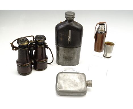 A pair of field glasses, a leather bound glass flask and two others similar