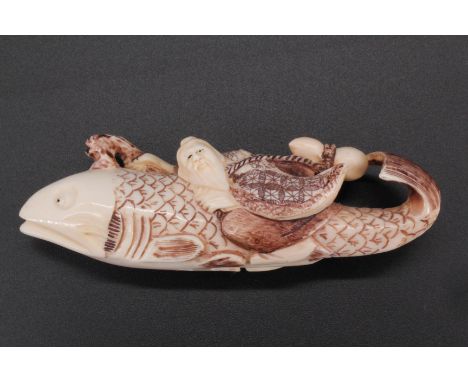 A Japanese Ivory netsuke of a sage riding a fish, 8 cm