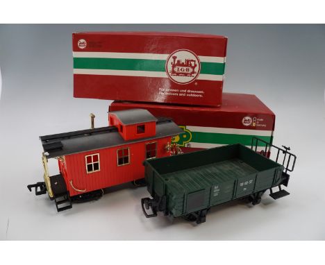 Three boxed L.G.B. garden model railway carriages including "Red Caboose", together with a "Work Caboose", g-scale