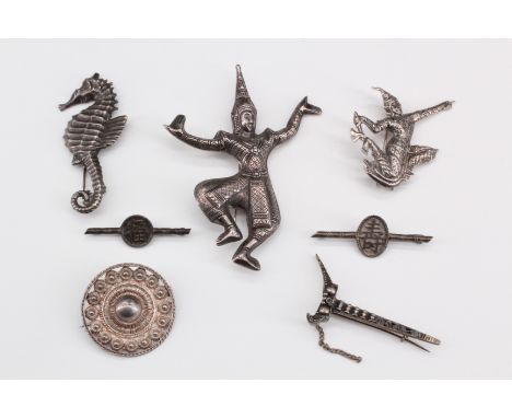 Four silver Siamese brooches, two being hollow repousse formed brooches depicting dancers, marked "sterling", largest 86 mm h