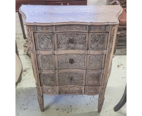 COMMODE, late 19th/early 20th century Italian limed oak having a serpentine shaped top above three drawers with floral carved