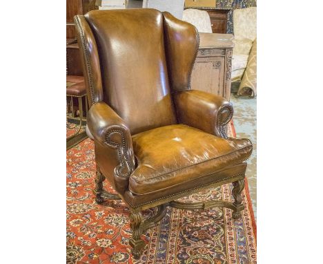 WING ARMCHAIR, 17th century style, oak and vintage tan leather, upholstered with stretchered supports, 86cm W.