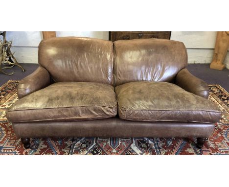 GEORGE SMITH STYLE SOFA, two seater, having vintage hand stitched soft studded leaf brown leather and turned front supports, 