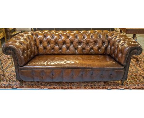 CHESTERFIELD SOFA, Victorian deep button upholstered, hand finished leaf brown leather with curved back and arms, turned waln