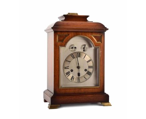 An early 20th century mahogany caddy top bracket clock. With brass inlay and brass handle. Silvered dial with Roman numeral c