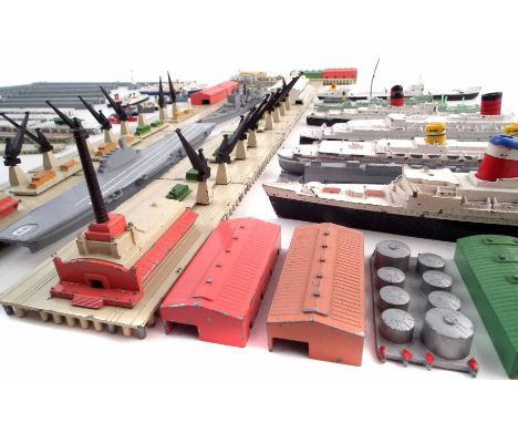 A collection of Triang Minic ships, Breakwaters, Quay Straights, Storage tanks and buildings to include S.S. United States, S