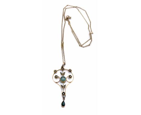 An Edwardian 9ct gold aquamarine and seed pearl set drop pendant, the Art Nouveau scrollwork design pendant comprising a roun