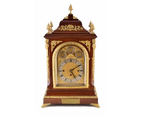 A 19th century mahogany gothic bracket clock. With stepped caddy pediment, gilded finials, spandrels and fretwork on the fron