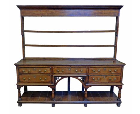George II oak dresser, rack with moulded cornice, three shelves standing on base with planked top ogee mould, five short draw