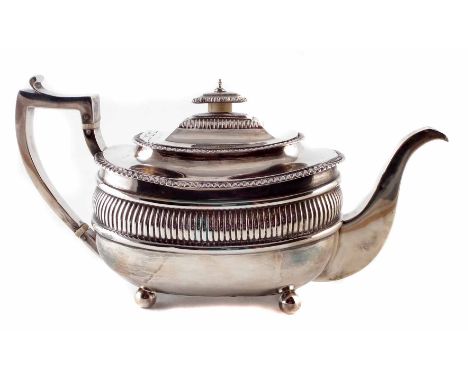 George III silver teapot by William Bennett, rounded rectangular body with fluted decoration on four ball feet, harp-shaped h