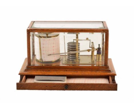 Edwardian oak case barograph. With brass fittings and inkwell stand. Drawer contains barograph manual and additional graph pa