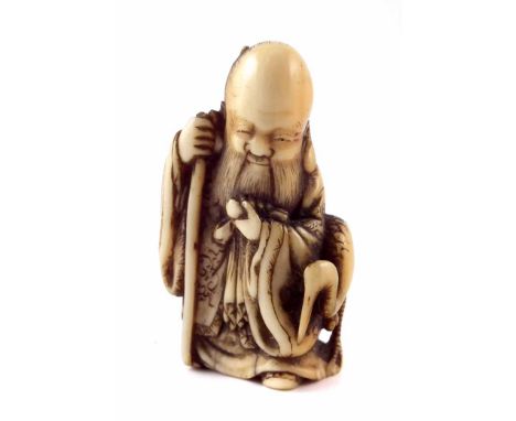 19th century Japanese Netsuke Fukurokuju holding a staff accompanied by a crane, signed Tomochika, height 3.8cm.