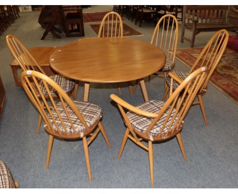 An Ercol light elm drop leaf dining table, together with a set of six matching chairs, including two carvers, table measures 