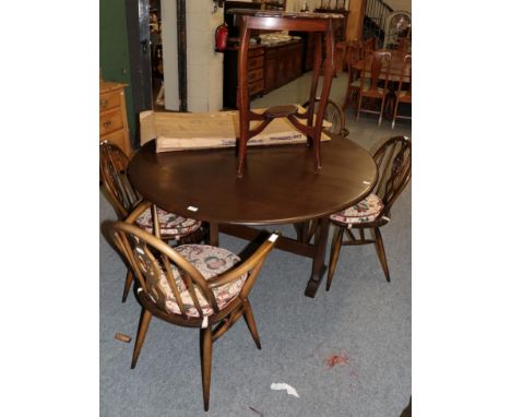 An Ercol dark elm dining suite, comprising table, four chairs (including two carvers) and sideboard (6)