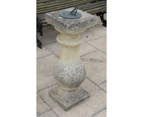 A weathered composition baluster sundial 