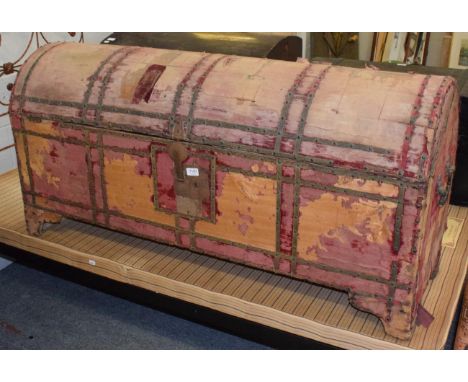 A dome topped slender trunk, possibly 17th century and possibly eastern with remains of red velvet upholster and studded deco
