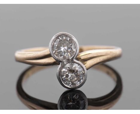 An 18ct and platinum two stone diamond ring, the collet mounted round brilliant cut diamonds, total estimated approx. 0.56cts