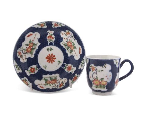 An 18th Century Worcester porcelain cup and saucer, the blue ground with reserves in Kakiemon stylegood condition no sign of 