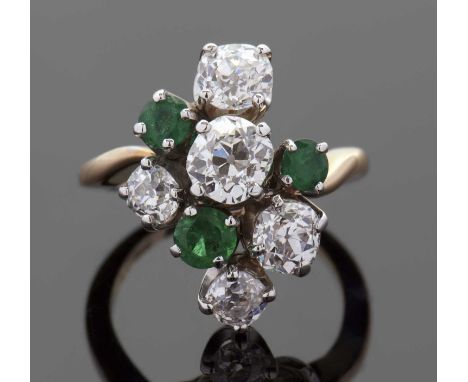 An emerald and diamond ring, the asymetric cluster set with round emeralds and round old mine cut diamonds, total weight of d