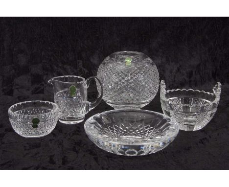 A group of Waterford glass wares including a globe, small jug, two bowls and further dish, all with typical cut glass designs
