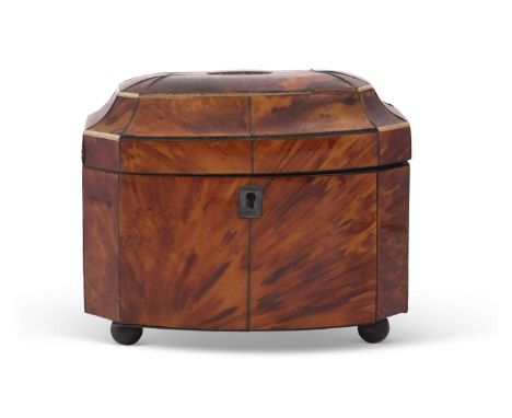 A Georgian tortoiseshell and ivory mounted tea caddy of bow front form, the hinged lid opening to an interior with two compar