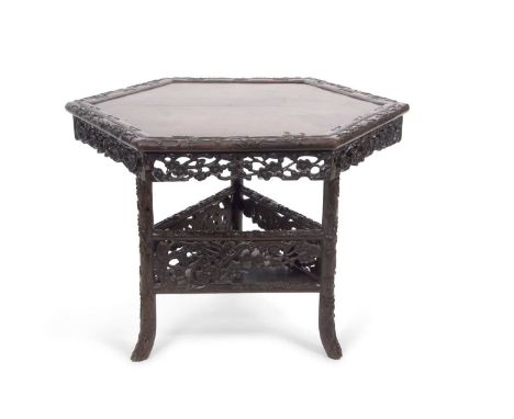 19th Century Chinese hardwood centre table with hexagonal top with carved and fretwork freize raised on a triangular support 