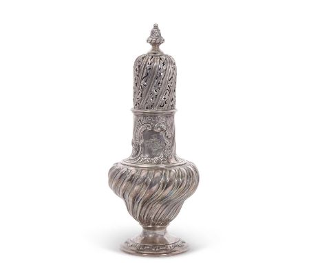 A George III large silver caster having a pull-off pierced cover, urn finial, the neck engraved with a crest, the baluster bo