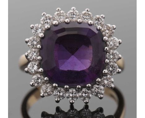 An 18ct amethyst and diamond ring, the cushion cut amethyst, surrounded by round brilliant cut diamonds, total estimated appr